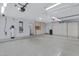 Organized garage with built-in cabinets, utility connections, and ample storage space at 11413 S Coolwater Dr, Goodyear, AZ 85338