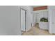 Neutral hallway featuring tile flooring, doorways, and white cabinets with drawers at 11413 S Coolwater Dr, Goodyear, AZ 85338