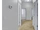 Hallway with tile flooring, multiple entryways, and neutral color scheme at 11413 S Coolwater Dr, Goodyear, AZ 85338