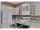 Close-up on the kitchen island with granite countertops and stainless steel appliances at 11413 S Coolwater Dr, Goodyear, AZ 85338
