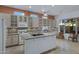Well-lit kitchen with granite countertops, a tile backsplash, and stainless steel appliances at 11413 S Coolwater Dr, Goodyear, AZ 85338