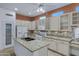 Well-equipped kitchen featuring white appliances, an island, and a tiled backsplash at 11413 S Coolwater Dr, Goodyear, AZ 85338
