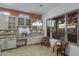 Bright kitchen with island, desk area, plenty of sunlight, and neutral colors at 11413 S Coolwater Dr, Goodyear, AZ 85338