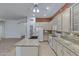 Kitchen with island, granite countertops, stainless appliances, and opens to the living area at 11413 S Coolwater Dr, Goodyear, AZ 85338