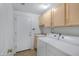 Functional laundry room with storage cabinets, sink, and modern washer and dryer units at 11413 S Coolwater Dr, Goodyear, AZ 85338