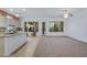 Bright open-concept living space seamlessly connects kitchen and living room with lots of natural light at 11413 S Coolwater Dr, Goodyear, AZ 85338