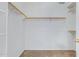 Spacious walk-in closet featuring carpet, white walls, and ample wood shelving at 11413 S Coolwater Dr, Goodyear, AZ 85338