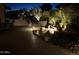 Atmospheric backyard at night, featuring soft lighting and a tranquil water feature at 12950 W Quinto Dr, Sun City West, AZ 85375
