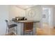 Cozy bar area with granite countertops, modern stools, and ample cabinet space at 12950 W Quinto Dr, Sun City West, AZ 85375