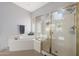 Primary bathroom featuring soaking tub and glass enclosed shower at 12950 W Quinto Dr, Sun City West, AZ 85375