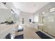 Bright primary bathroom with dual sinks, soaking tub, and walk-in shower at 12950 W Quinto Dr, Sun City West, AZ 85375