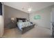 Comfortable bedroom with ceiling fan, neutral color scheme and ensuite bathroom at 12950 W Quinto Dr, Sun City West, AZ 85375