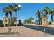 Secure gated community entrance with palm trees, providing privacy and an exclusive feel at 12950 W Quinto Dr, Sun City West, AZ 85375