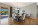 Elegant dining room features a chandelier, a table with six chairs, and natural light streaming through sliding glass doors at 12950 W Quinto Dr, Sun City West, AZ 85375