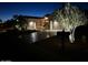 Charming single-story home with desert landscaping, a long driveway, a two-car garage, and landscape lighting at 12950 W Quinto Dr, Sun City West, AZ 85375