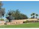 Inviting community entrance sign with beautiful landscaping and a charming fountain, creating a picturesque welcome at 12950 W Quinto Dr, Sun City West, AZ 85375