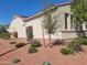 Beautiful home exterior featuring desert landscaping with flowers and a stucco facade at 12950 W Quinto Dr, Sun City West, AZ 85375