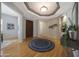 Spacious foyer featuring hardwood floors, stylish decor, and a striking tray ceiling at 12950 W Quinto Dr, Sun City West, AZ 85375