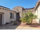 Inviting front entrance with stone accents, solar panels, a desert garden, and a tiled roof at 12950 W Quinto Dr, Sun City West, AZ 85375