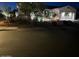 Charming single-story home with desert landscaping, a well-lit walkway, and a two-car garage at 12950 W Quinto Dr, Sun City West, AZ 85375