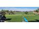 Golf course view with players, golf carts, and manicured greens, highlighting the community's recreational offerings at 12950 W Quinto Dr, Sun City West, AZ 85375