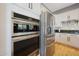 Kitchen featuring stainless steel appliances including double oven and refrigerator at 12950 W Quinto Dr, Sun City West, AZ 85375