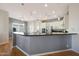 Modern kitchen featuring a breakfast bar, stainless steel appliances, and sleek countertops under recessed lighting at 12950 W Quinto Dr, Sun City West, AZ 85375