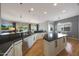 Bright kitchen with white cabinetry, stainless steel appliances, and a view into the adjacent living and dining spaces at 12950 W Quinto Dr, Sun City West, AZ 85375