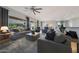 Bright living room with neutral color scheme, comfortable seating, and stylish decor and ceiling fan at 12950 W Quinto Dr, Sun City West, AZ 85375