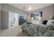 Spacious main bedroom featuring a ceiling fan, TV, a large window, and an ensuite bathroom at 12950 W Quinto Dr, Sun City West, AZ 85375