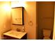 Cozy bathroom with a white sink and toilet and a dark framed mirror at 1490 W Laurel Ave, Gilbert, AZ 85233