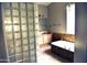 Serene bathroom featuring a soaking tub and glass block accents at 1490 W Laurel Ave, Gilbert, AZ 85233