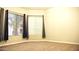 Bright bedroom featuring neutral carpet, two windows, and neutral paint at 1490 W Laurel Ave, Gilbert, AZ 85233