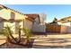 Charming home exterior showcasing a well-maintained front yard with palm trees at 1490 W Laurel Ave, Gilbert, AZ 85233
