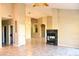 Spacious living room featuring tile floors, a modern fireplace, and plenty of natural light at 1490 W Laurel Ave, Gilbert, AZ 85233