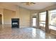 Spacious living room featuring tile floors, a modern fireplace, and plenty of natural light at 1490 W Laurel Ave, Gilbert, AZ 85233