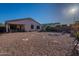 Backyard features desert landscaping, covered patio, and privacy walls at 1642 E Cardinal Dr, Casa Grande, AZ 85122