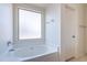Bathroom featuring soaking tub under a window providing natural light, and a separate toilet room at 1642 E Cardinal Dr, Casa Grande, AZ 85122