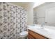 Bright bathroom features a vanity with a sink, a decorative shower curtain, and a toilet at 1642 E Cardinal Dr, Casa Grande, AZ 85122