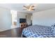 Bedroom includes wood floors, neutral walls, ceiling fan and leads into an attached bathroom at 1642 E Cardinal Dr, Casa Grande, AZ 85122