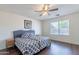 Bedroom with wood floors, ceiling fan, and a large window with a pleasant view at 1642 E Cardinal Dr, Casa Grande, AZ 85122