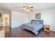Bedroom features wood floors, ceiling fan, and is furnished with a cozy bed and nightstand at 1642 E Cardinal Dr, Casa Grande, AZ 85122