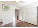 Well-lit bedroom with wood-look flooring, white walls, and closet with sliding doors at 1642 E Cardinal Dr, Casa Grande, AZ 85122
