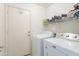 Clean laundry room equipped with washer, dryer, utility sink and shelving at 1642 E Cardinal Dr, Casa Grande, AZ 85122