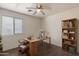 Modern office space with wood floors, shelving, a ceiling fan, and an desk with computer at 1642 E Cardinal Dr, Casa Grande, AZ 85122