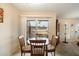 Cozy dining area features a wood table, four chairs and a sliding glass door with balcony view at 17010 E Calle Del Oro -- # D, Fountain Hills, AZ 85268