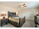 Spacious main bedroom boasts rustic wood bed frame, ceiling fan, and large closet at 17010 E Calle Del Oro -- # D, Fountain Hills, AZ 85268