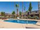 Refreshing community pool surrounded by palm trees, perfect for relaxation at 17010 E Calle Del Oro -- # D, Fountain Hills, AZ 85268
