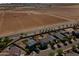 An aerial view highlights a community with a house that backs up to farmland at 17043 N Avelino Dr, Maricopa, AZ 85138