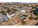Aerial view of a Gathering-friendly neighborhood with a park, lake, and above-ground pools at 17043 N Avelino Dr, Maricopa, AZ 85138